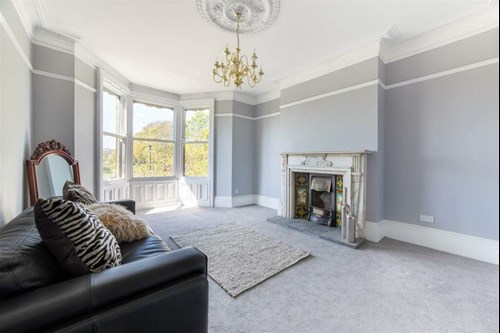 Living room of maisonette with traditional fireplace